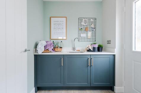 The utility is just off the kitchen with access to the driveway