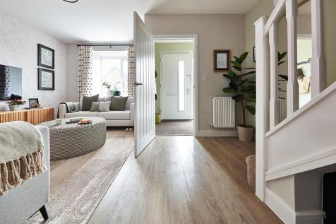 The inviting and spacious lounge offers space for fitted storage under the stairs