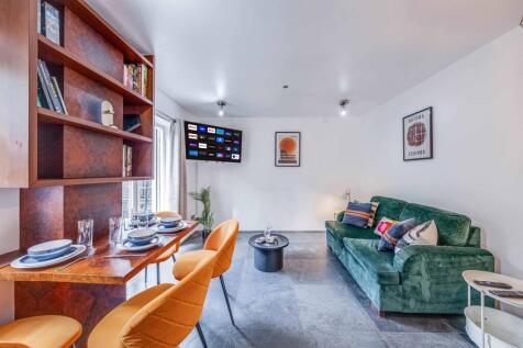 Bright and contemporary living room featuring a...