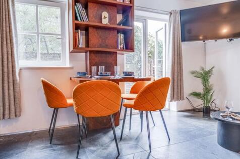 Bright and stylish living room featuring a cozy...
