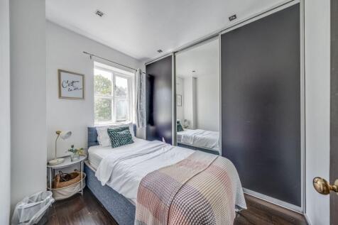 A cozy and well-kept single bedroom featuring a...