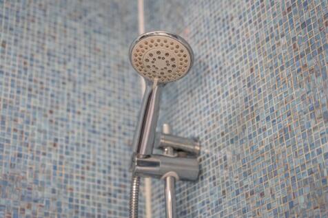 Close-up view of a modern chrome showerhead aga...
