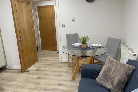 A clean and inviting living room featuring a mo...