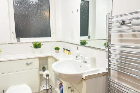 A bright and modern bathroom featuring sleek fi...