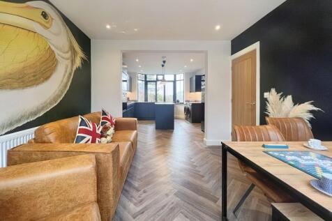 A stylish and modern living room featuring a wa...