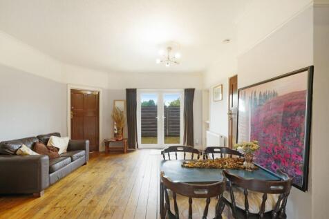 A warm and inviting living room featuring a com...