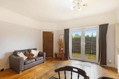 A cozy living room featuring a comfortable leat...