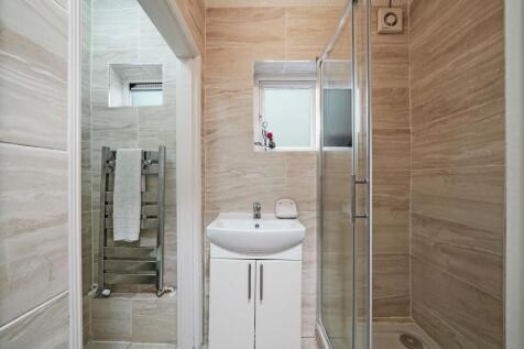 Bright and clean bathroom featuring elegant bei...