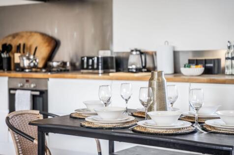 This stylish kitchen features a modern design w...
