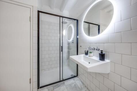 Modern bathroom featuring a spacious glass show...