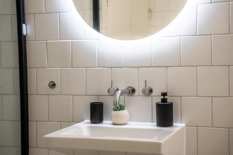 This modern bathroom features a sleek design wi...