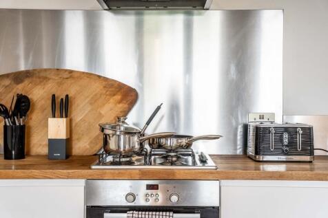 Modern kitchen featuring sleek stainless steel ...