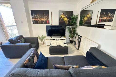 A bright and modern living room featuring styli...