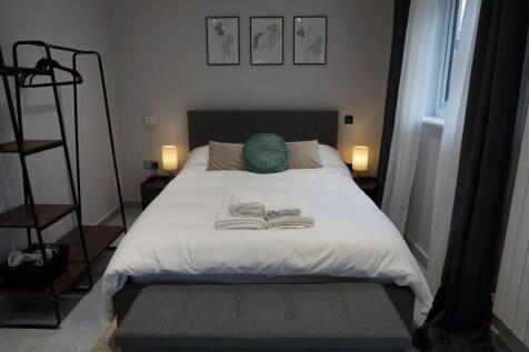 A cozy and well-kept double bedroom featuring a...