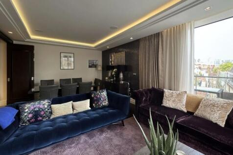 A stylish contemporary living room featuring pl...