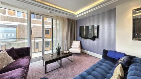 A stylish and contemporary living room featurin...