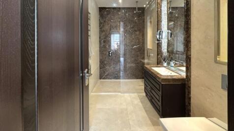 A luxurious bathroom suite featuring elegant ma...