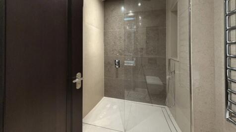 A sleek, modern bathroom suite featuring a spac...