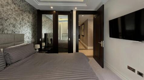 A stylish double bedroom featuring a comfortabl...