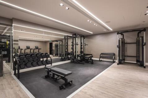 A modern, well-equipped gym featuring a variety...