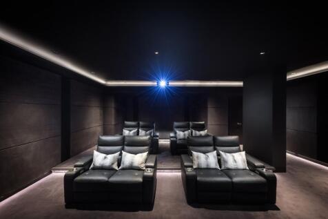A sleek and modern private cinema room featurin...