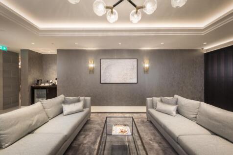 A sleek and modern communal lounge featuring tw...