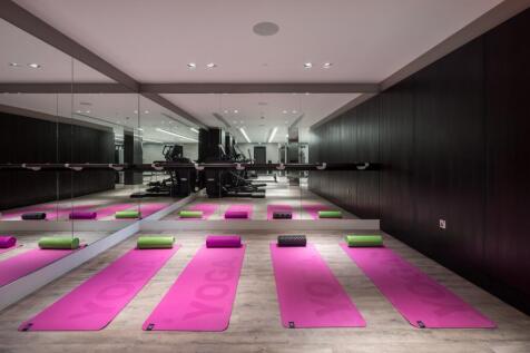 A sleek and modern gym space featuring multiple...