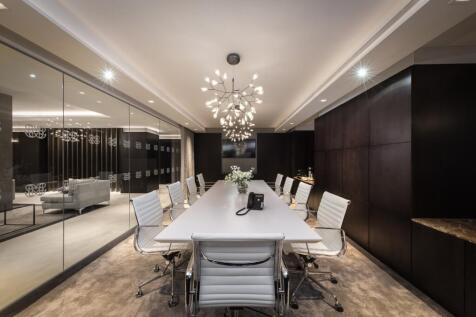A sleek, modern communal workspace featuring a ...