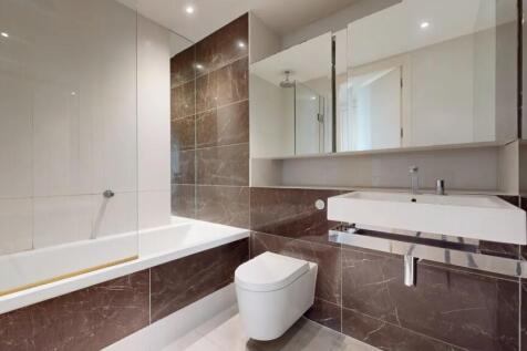 Modern bathroom suite featuring a sleek bathtub...