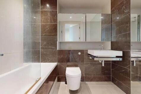 A sleek, modern bathroom suite featuring a larg...