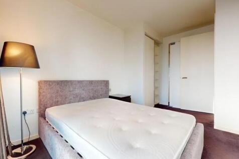 A clean and bright double bedroom featuring a p...