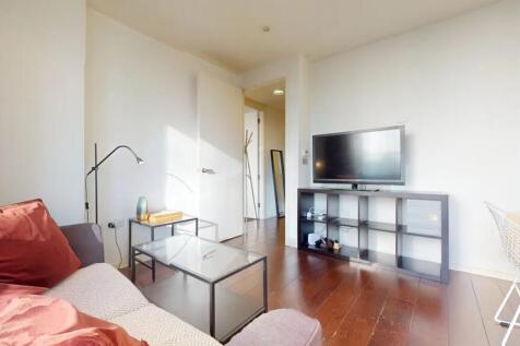 Bright and modern living room featuring a comfo...