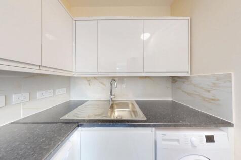 Bright and clean kitchen space featuring modern...