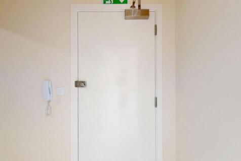 A clean and well-maintained hallway with a whit...