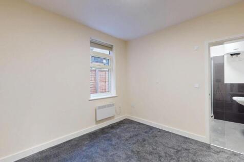 A clean and simple small room featuring a moder...