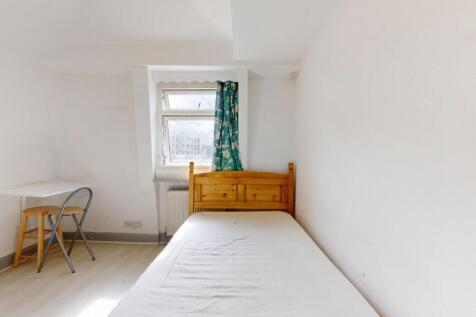 Bright and tidy single bedroom featuring a wood...