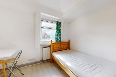 A bright and tidy single bedroom featuring a wo...
