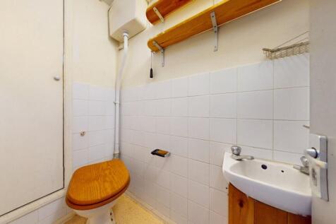 A compact and functional single toilet featurin...