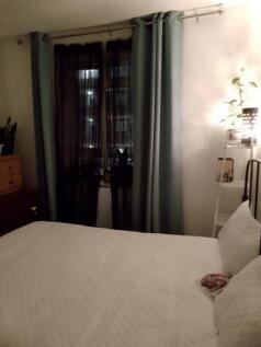 Cozy double bedroom featuring a comfortable bed...
