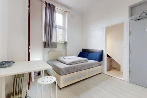 A bright and tidy single bedroom featuring a co...
