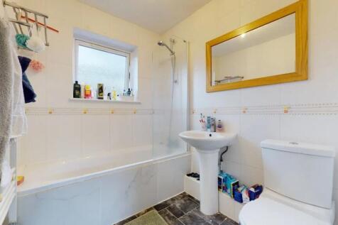 Bright bathroom suite featuring a clean, modern...