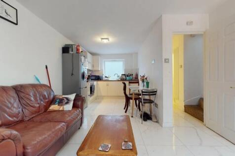 A bright and inviting living room with a leathe...