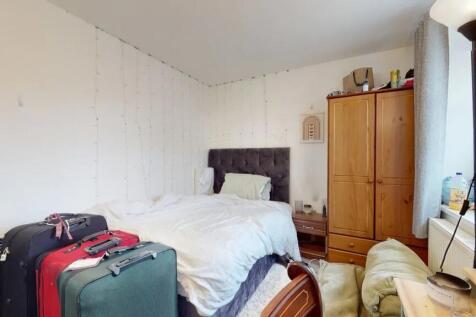 A cozy double bedroom featuring a plush dark he...