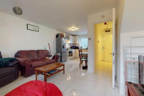 A well-lit living room featuring comfortable le...