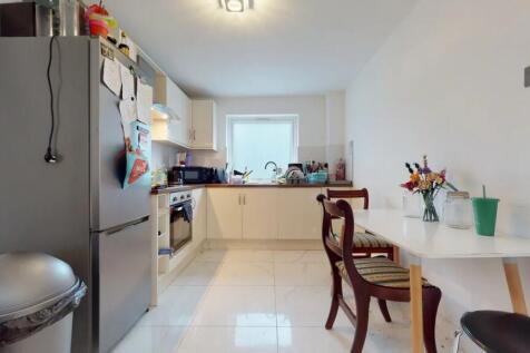 Bright and tidy kitchen featuring modern applia...