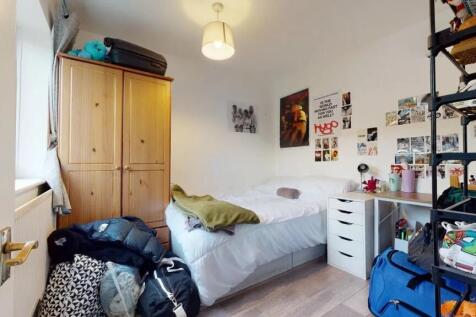 A cozy double bedroom featuring a neatly made b...