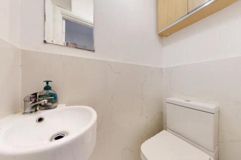 Bright and clean single toilet featuring modern...