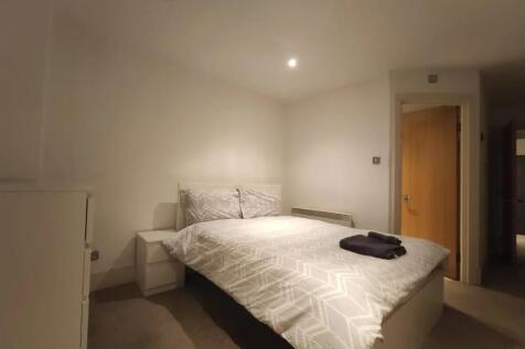 A neat and simple double bedroom featuring a we...