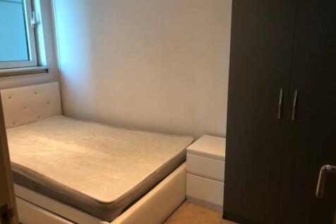 A neat double bedroom featuring a comfortable u...