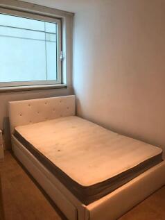 A cozy double bedroom featuring a clean, uphols...
